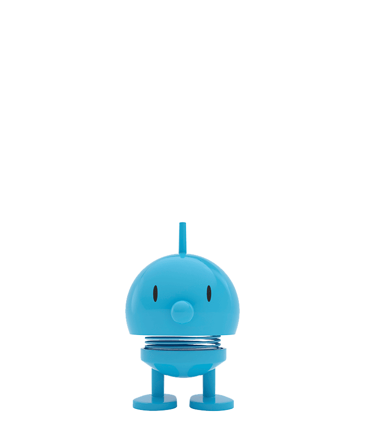 Der Hoptimist Bumble Small Turquoise von Hoptimist ist eine kleine, runde Spielfigur in Türkis mit federnder Mitte, zwei flachen Füßen, einfachen Augen, einer schnabelartigen Nase, einer kurzen Antenne oben und einem optimistischen Lächeln.